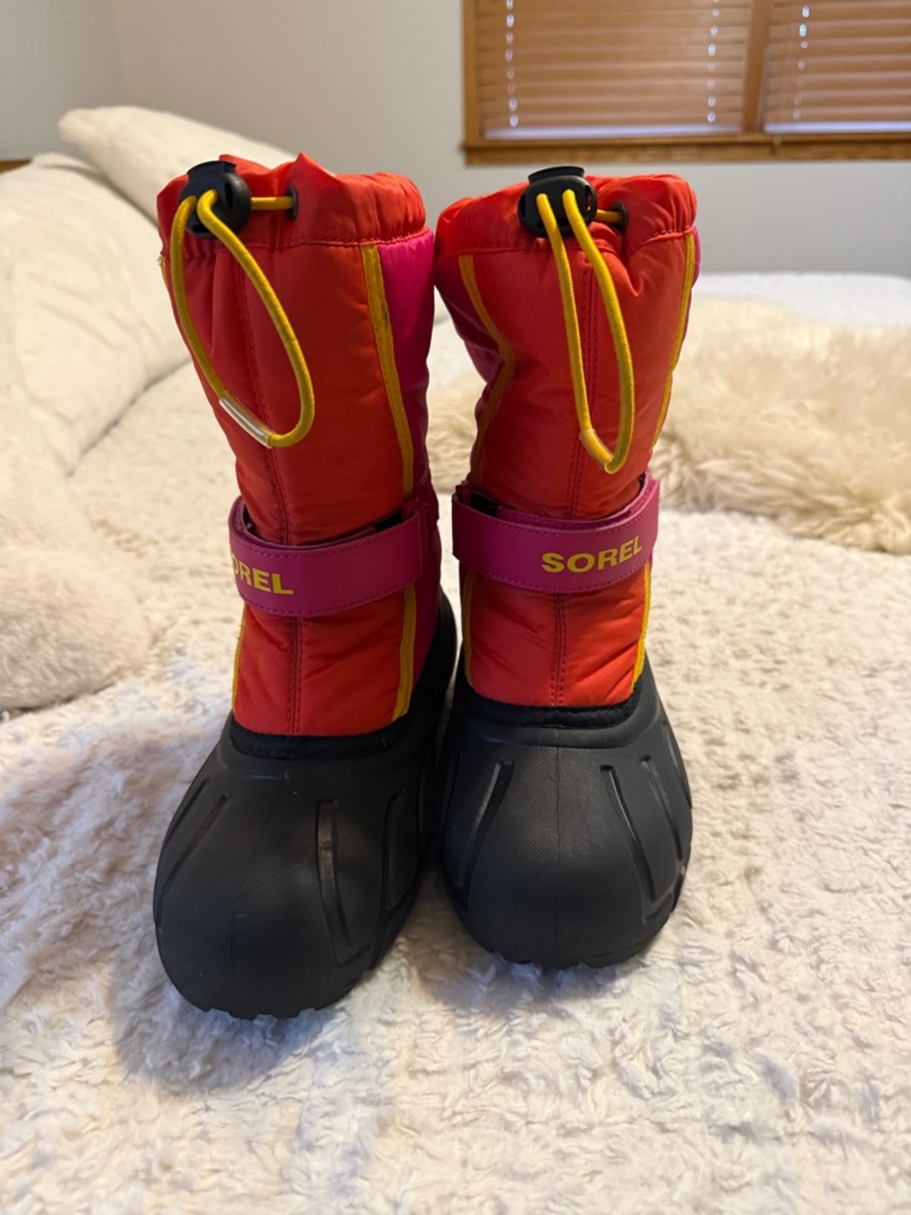 Sorel kids' red and pink winter snow boots with yellow accents